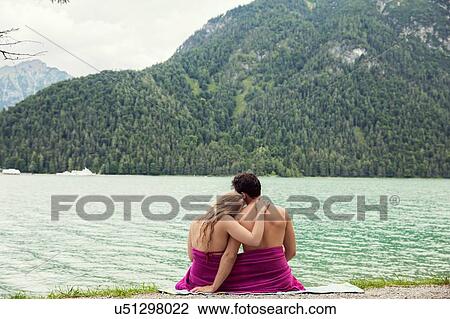Couple wrapped in towel by Achensee, Innsbruck, Tirol, Austria, Europe View Large Photo Image Stock Image - Couple wrapped in towel by Achensee, Innsbruck, Tirol, Austria, Europe. Fotosearch