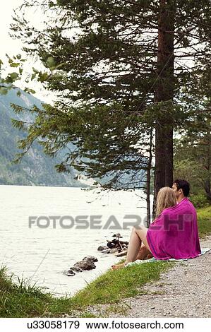 Couple wrapped in towel by Achensee, Innsbruck, Tirol, Austria, Europe View Large Photo Image Stock Photo - Couple wrapped in towel by Achensee, Innsbruck, Tirol, Austria, Europe. Fotosearch