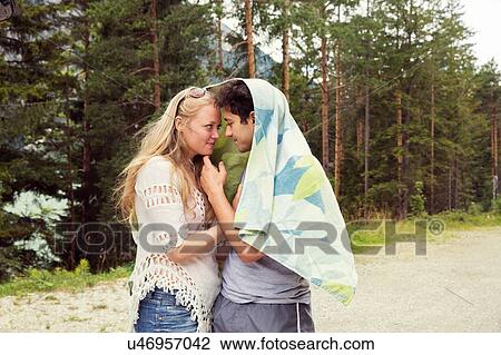 Couple wrapped in towel, face to face hugging View Large Photo Image Stock Image - Couple wrapped in towel, face to face hugging. Fotosearch