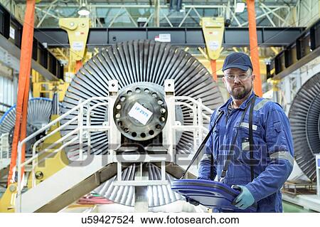 Picture - Crane operator with low pressure steam turbines in turbine maintenance factory. Fotosearch