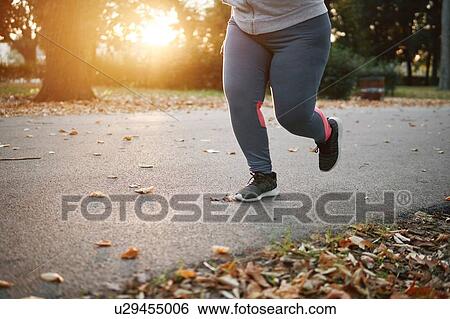 Curvaceous young female runner running in park, waist down View Large Photo Image Stock Photograph - Curvaceous young female runner running in park, waist down. Fotosearch