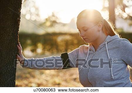 Curvaceous young woman training in park, doing tree trunk push ups View Large Photo Image Stock Image - Curvaceous young woman training in park, doing tree trunk push ups. Fotosearch
