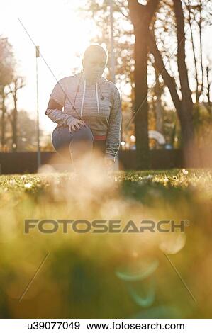 Curvaceous young woman training in park, leaning forward and crouching View Large Photo Image Stock Photo - Curvaceous young woman training in park, leaning forward and crouching. Fotosearch