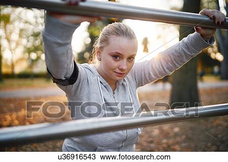 Curvaceous young woman training, portrait leaning against handrail in park View Large Photo Image Stock Image - Curvaceous young woman training, portrait leaning against handrail in park. Fotosearch
