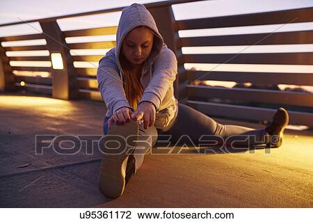 Curvaceous young woman training, touching toes on footbridge View Large Photo Image Stock Image - Curvaceous young woman training, touching toes on footbridge. Fotosearch