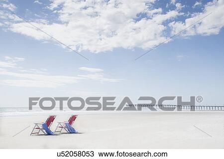 Deck chairs on sandy beach by Atlantic Ocean View Large Photo Image Stock Image - Deck chairs on sandy beach by Atlantic Ocean. Fotosearch
