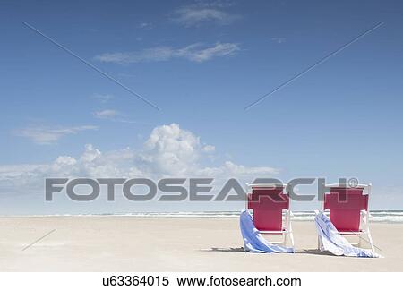 Deck chairs with towels on sandy beach by Atlantic Ocean View Large Photo Image Stock Photography - Deck chairs with towels on sandy beach by Atlantic Ocean. Fotosearch