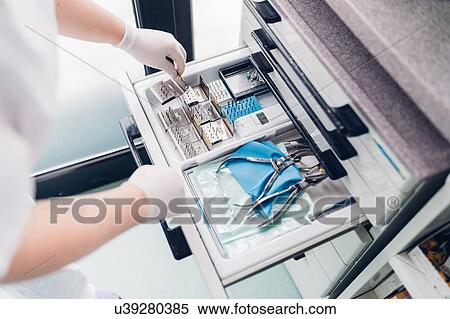 Dental nurse preparing dentistry equipment, close-up, elevated view View Large Photo Image Stock Photography - Dental nurse preparing dentistry equipment, close-up, elevated view. Fotosearch