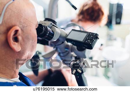 Dentist and dental nurse carrying out procedure on patient View Large Photo Image Stock Photography - Dentist and dental nurse carrying out procedure on patient. Fotosearch