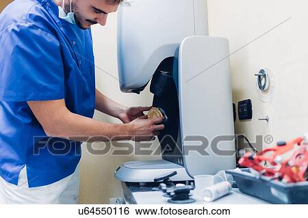 Dentist making false teeth in laboratory View Large Photo Image Stock Photograph - Dentist making false teeth in laboratory. Fotosearch