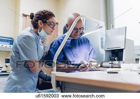 Dentist polishing denture in laboratory, female dentist watching process View Large Photo Image Stock Image - Dentist polishing denture in laboratory, female dentist watching process. Fotosearch