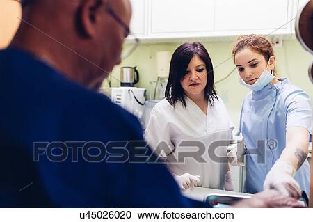 Stock Image - Dentists in dentist office. Fotosearch