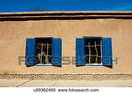Stock Photo - Detail of building exterior with blue window shutters, San Pedro de Atacama, Atacama Desert, Chile. Fotosearch