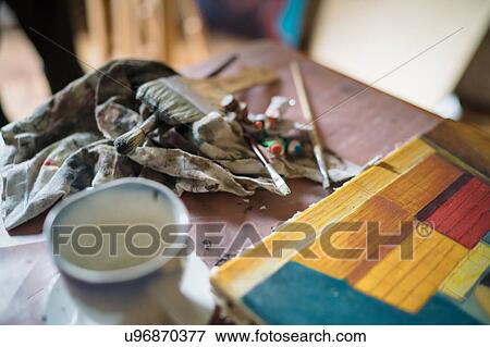 Detail of canvas painting and brushes on artists studio table View Large Photo Image Stock Photo - Detail of canvas painting and brushes on artists studio table. Fotosearch