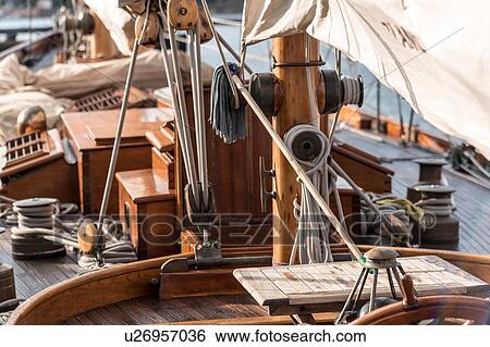 Stock Photograph - Detail of rope and sails on traditional boat deck, Porquerolles, Provence-Alpes-Cote d'Azur. Fotosearch