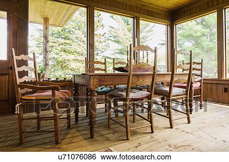Dining table and chairs, treated wood floorboards inside country home, Quebec, Canada View Large Photo Image Stock Photograph - Dining table and chairs, treated wood floorboards inside country home, Quebec, Canada. Fotosearch