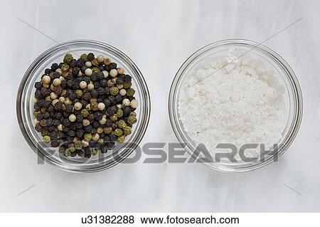 Stock Photo - Directly above view of pepper and sea salt. Fotosearch