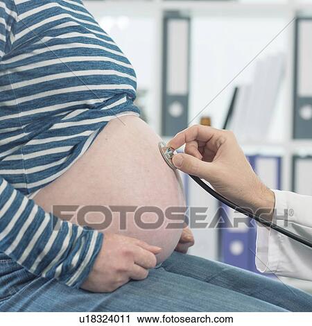 Doctor examining pregnant woman with stethoscope. View Large Photo Image Stock Image - Doctor examining pregnant woman with stethoscope.. Fotosearch
