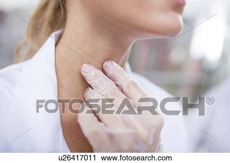 Doctor feeling her larynx. View Large Photo Image Stock Image - Doctor feeling her larynx.. Fotosearch