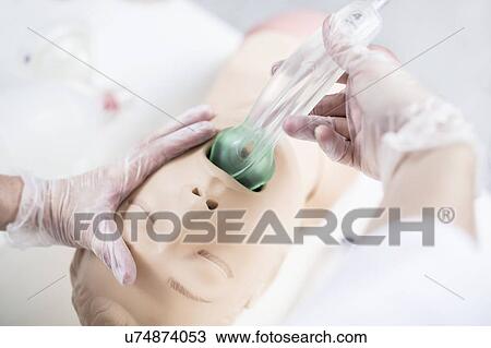 Doctor practising tracheal intubation on a training dummy. View Large Photo Image Stock Image - Doctor practising tracheal intubation on a training dummy.. Fotosearch