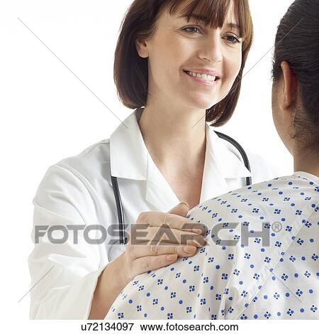 Stock Photo - Doctor with her hand on patient's shoulder.. Fotosearch