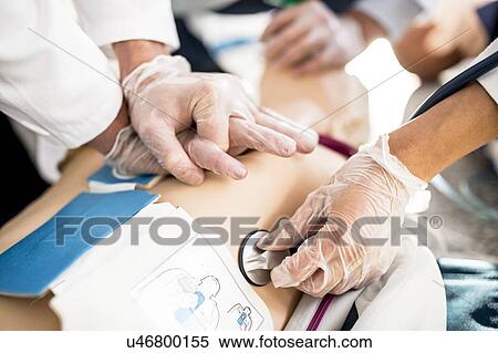Doctors undertaking CPR training on dummies. View Large Photo Image Stock Photography - Doctors undertaking CPR training on dummies.. Fotosearch