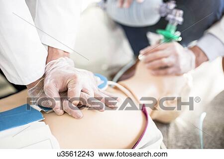 Doctors undertaking CPR training View Large Photo Image Stock Image - Doctors undertaking CPR training. Fotosearch