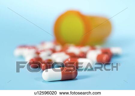 Drug capsules spilling from bottle. View Large Photo Image Stock Image - Drug capsules spilling from bottle.. Fotosearch