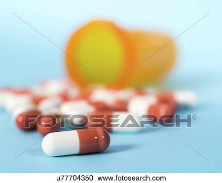 Drug capsules spilling from bottle. View Large Photo Image Stock Image - Drug capsules spilling from bottle.. Fotosearch