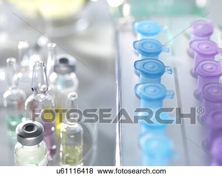 Drug Development. A variety of potential new drugs in a petri dish with a row of vials used in pharmaceutical research. View Large Photo Image Stock Photo - Drug Development. A variety of potential new drugs in a petri dish with a row of vials used in pharmaceutical research.. Fotosearch