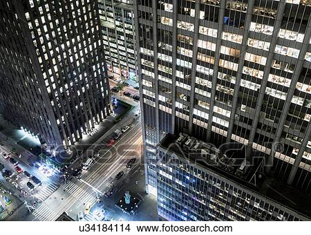 Picture - Elevated view of street at night, skyscraper in foreground, New York City, New York, USA. Fotosearch