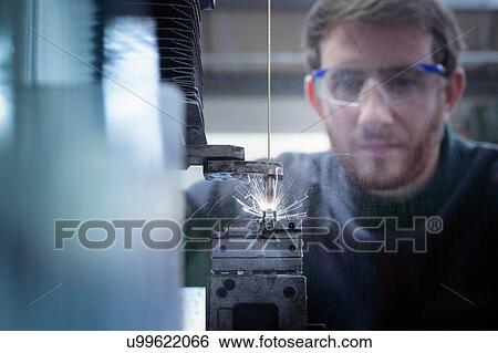 Engineer fast hole drilling using electrical discharge drill in precision engineering factory View Large Photo Image Stock Photograph - Engineer fast hole drilling using electrical discharge drill in precision engineering factory. Fotosearch