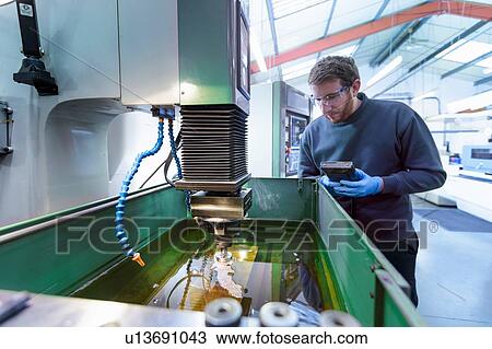 Engineer operating solid EDM (Spark Erosion Machine) in precision engineering factory View Large Photo Image Stock Image - Engineer operating solid EDM (Spark Erosion Machine) in precision engineering factory. Fotosearch