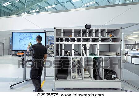Engineer using artificial intelligence aid to pick parts for product assembly in robotics research facility View Large Photo Image Stock Photography - Engineer using artificial intelligence aid to pick parts for product assembly in robotics research facility. Fotosearch
