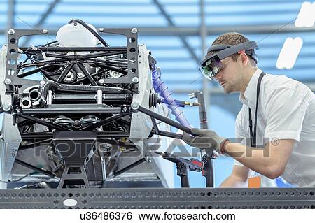 Engineer using augmented reality headset to 'see' parts position on car in assembly composite image showing CAD drawing of part in robotics research facility View Large Photo Image Stock Photograph - Engineer using augmented reality headset to 'see' parts position on car in assembly composite image showing CAD drawing of part in robotics research facility. Fotosearch