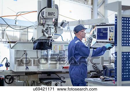 Engineer working at lathe in turbine maintenance factory View Large Photo Image Stock Image - Engineer working at lathe in turbine maintenance factory. Fotosearch