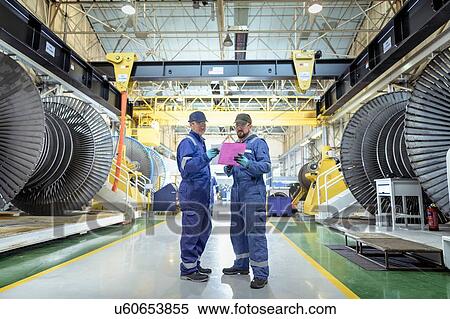 Engineers in discussion in turbine maintenance factory View Large Photo Image Stock Photography - Engineers in discussion in turbine maintenance factory. Fotosearch