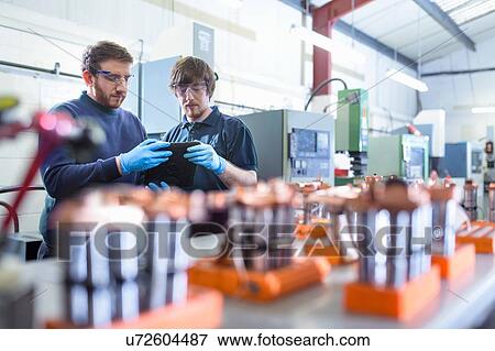 Engineers working with electrodes for electrical discharge machine in precision engineering factory View Large Photo Image Stock Photo - Engineers working with electrodes for electrical discharge machine in precision engineering factory. Fotosearch