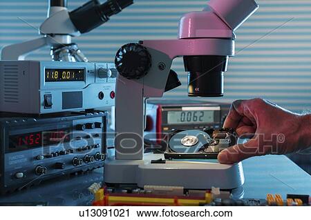 Examining hard drive with microscope. View Large Photo Image Stock Image - Examining hard drive with microscope.. Fotosearch