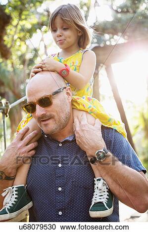 Father and daughter walking outdoors, father carrying daughter on shoulders View Large Photo Image Stock Image - Father and daughter walking outdoors, father carrying daughter on shoulders. Fotosearch