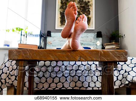 Feet resting on bench at end of bed View Large Photo Image Stock Photography - Feet resting on bench at end of bed. Fotosearch
