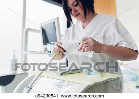 Female dentist in dentist office, preparing dentistry equipment View Large Photo Image Stock Image - Female dentist in dentist office, preparing dentistry equipment. Fotosearch