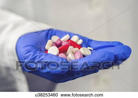 Female doctor with hand full of various pills and medications. View Large Photo Image Stock Image - Female doctor with hand full of various pills and medications.. Fotosearch