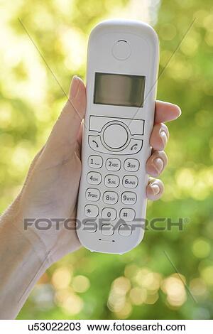 Female hand holding cordless landline telephone receiver. View Large Photo Image Stock Image - Female hand holding cordless landline telephone receiver.. Fotosearch