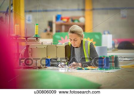 Female worker making cushions with sewing machine in factory View Large Photo Image Stock Photo - Female worker making cushions with sewing machine in factory. Fotosearch