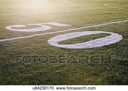 Fifty yard line on green playing field View Large Photo Image Stock Image - Fifty yard line on green playing field. Fotosearch