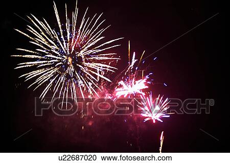 Stock Image - Fireworks exploding in night sky. Fotosearch