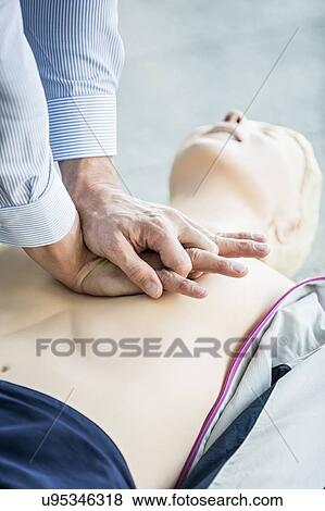 First-aider practising chest compressions on a CPR training dummy. View Large Photo Image Stock Photo - First-aider practising chest compressions on a CPR training dummy.. Fotosearch