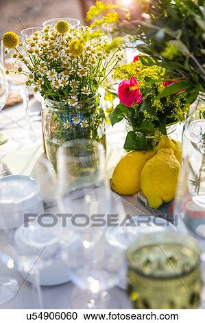 Stock Image - Flower arrangement on table setting. Fotosearch