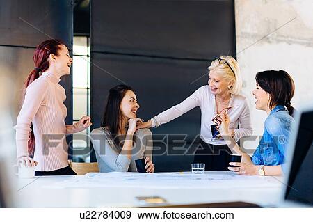 Four women in business meeting, laughing View Large Photo Image Stock Photo - Four women in business meeting, laughing. Fotosearch